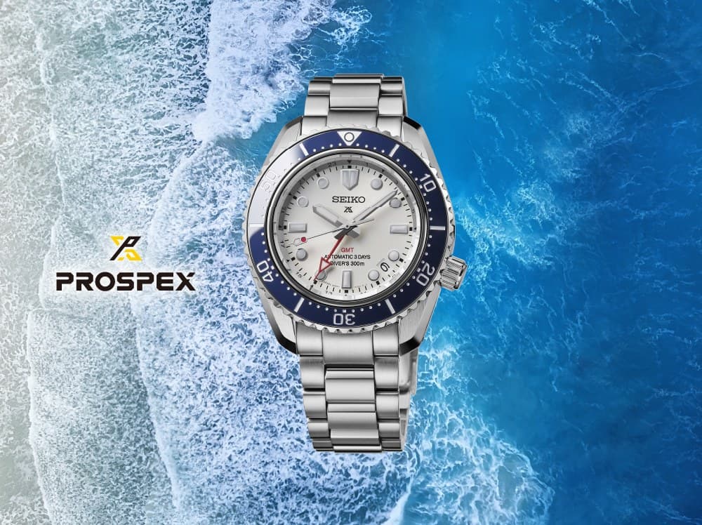 Seiko Prospex GMT diver with a white dial and blue bezel over an ocean wave